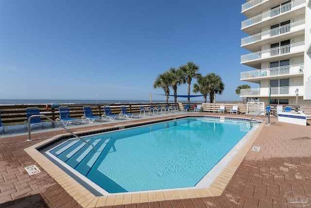 view of swimming pool featuring a water view