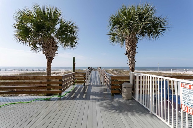 deck with a water view and a beach view