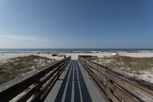 surrounding community with a water view and a view of the beach