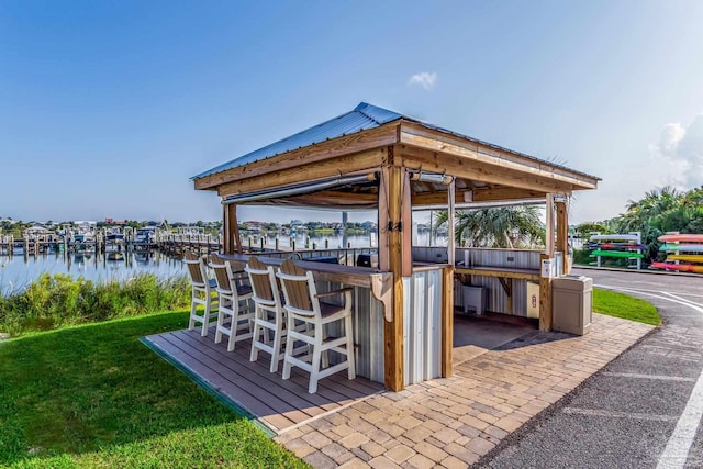 view of patio / terrace with a bar and a water view