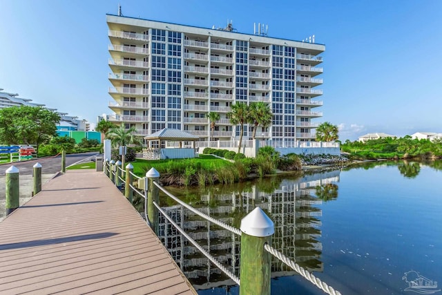 view of dock featuring a gazebo and a water view