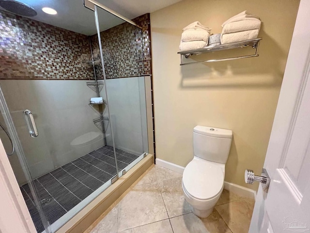 bathroom featuring toilet, tile patterned floors, and walk in shower