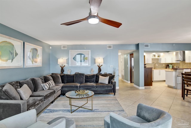 living room with light tile patterned flooring and ceiling fan