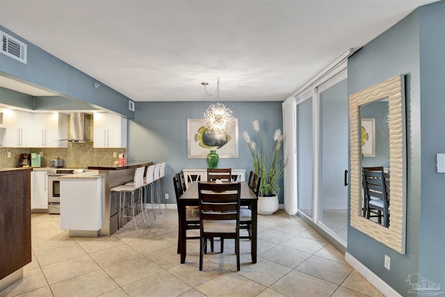 tiled dining space with a notable chandelier