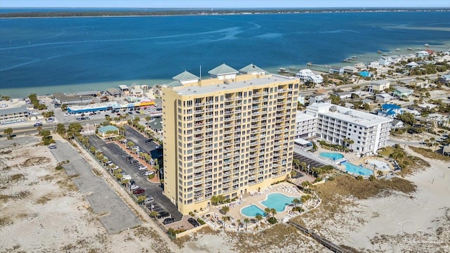 birds eye view of property with a water view and a view of the beach