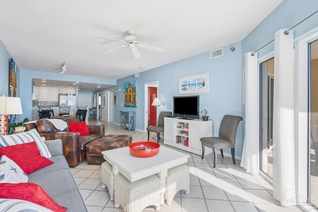 living room featuring ceiling fan and light tile patterned floors