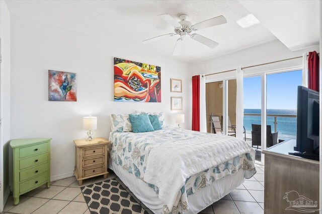 tiled bedroom featuring a textured ceiling, access to exterior, and ceiling fan