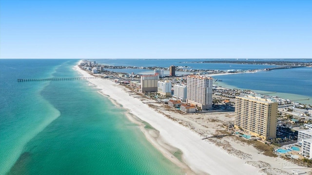 bird's eye view with a water view and a beach view