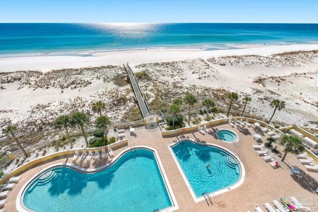 exterior space with a water view and a beach view