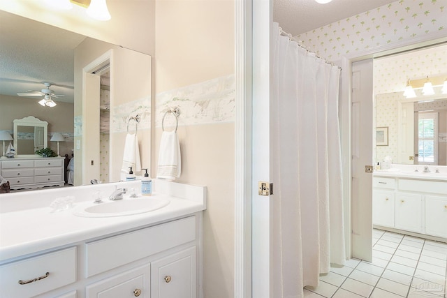 4200 Madura Rd, Gulf Breeze, FL 32563 - full bathroom featuring a sink, ceiling fan, wallpapered walls, two vanities, and tile patterned floors