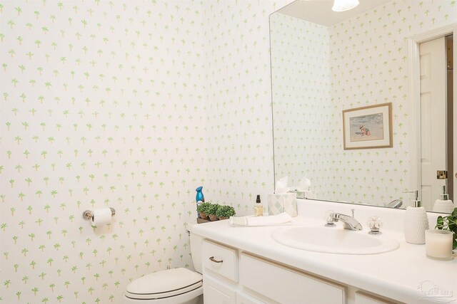 4200 Madura Rd, Gulf Breeze, FL 32563 - bathroom featuring wallpapered walls, toilet, and vanity