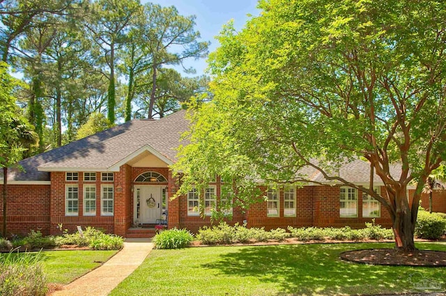4200 Madura Rd, Gulf Breeze, FL 32563 - view of front of house featuring brick siding, a front lawn, and roof with shingles