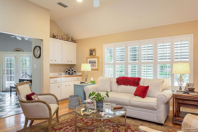 4200 Madura Rd, Gulf Breeze, FL 32563 - living room with lofted ceiling, visible vents, light wood-type flooring, and a ceiling fan