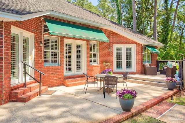 4200 Madura Rd, Gulf Breeze, FL 32563 - rear view of house featuring a patio, a shingled roof, entry steps, and brick siding