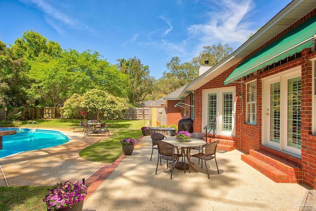 4200 Madura Rd, Gulf Breeze, FL 32563 - view of patio / terrace with outdoor dining space, french doors, a fenced backyard, and a fenced in pool
