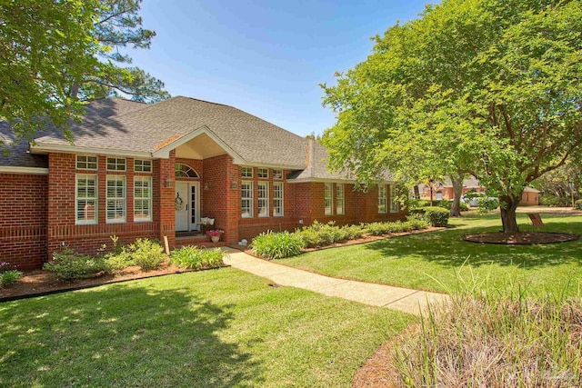 4200 Madura Rd, Gulf Breeze, FL 32563 - bungalow with brick siding, a front yard, and roof with shingles