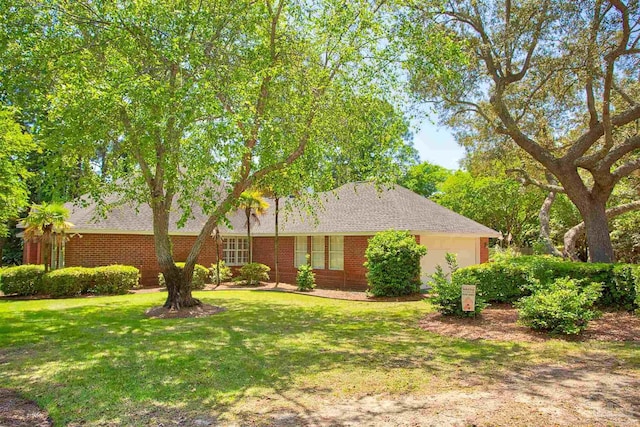 4200 Madura Rd, Gulf Breeze, FL 32563 - ranch-style house featuring brick siding, a front yard, and an attached garage