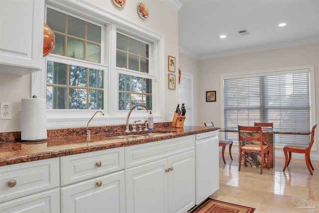 kitchen featuring white cabinetry, sink, crown molding, and dark stone countertops