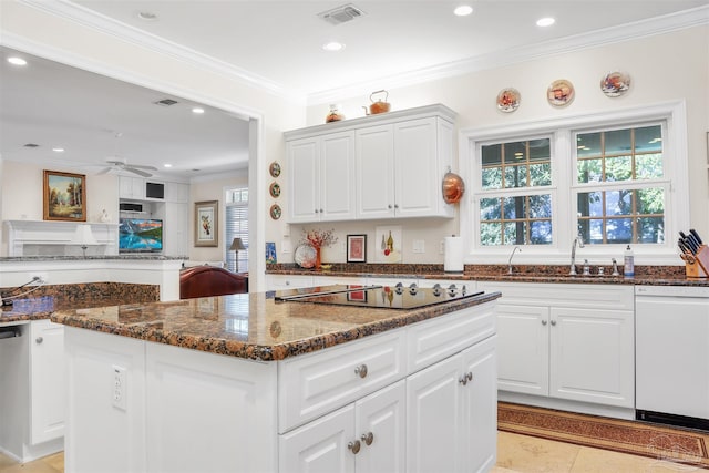 kitchen featuring white cabinetry, dark stone countertops, and white dishwasher