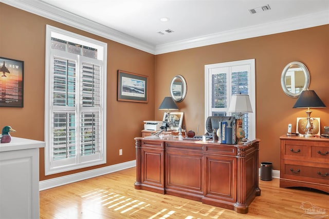 home office with crown molding and light hardwood / wood-style floors