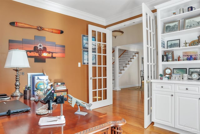 office featuring ornamental molding, light hardwood / wood-style floors, and french doors