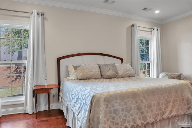 bedroom featuring crown molding and dark hardwood / wood-style flooring