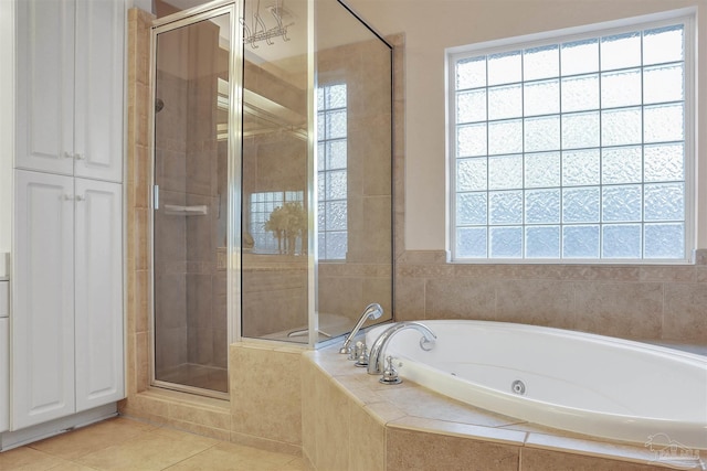 bathroom featuring tile patterned floors and independent shower and bath