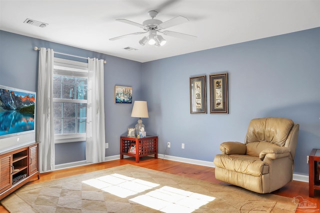 sitting room featuring hardwood / wood-style floors and ceiling fan