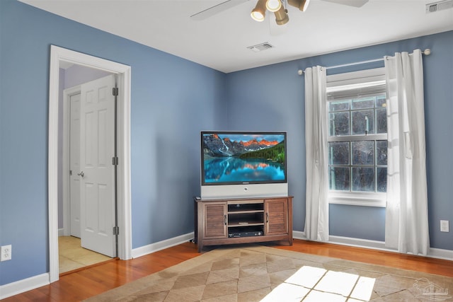 unfurnished living room with ceiling fan and light hardwood / wood-style flooring