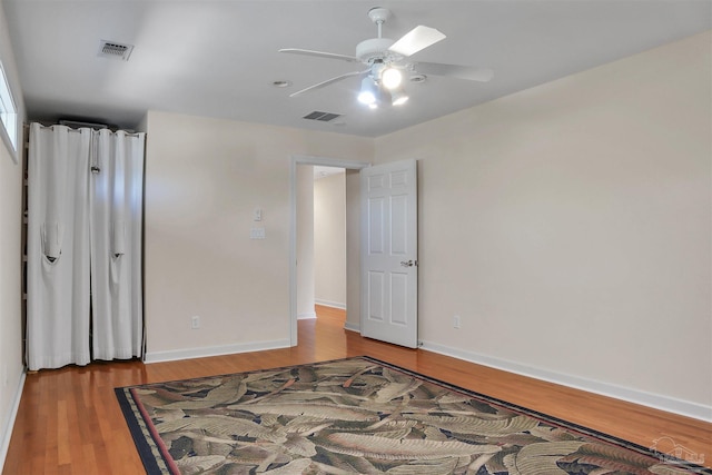 unfurnished room featuring hardwood / wood-style floors and ceiling fan