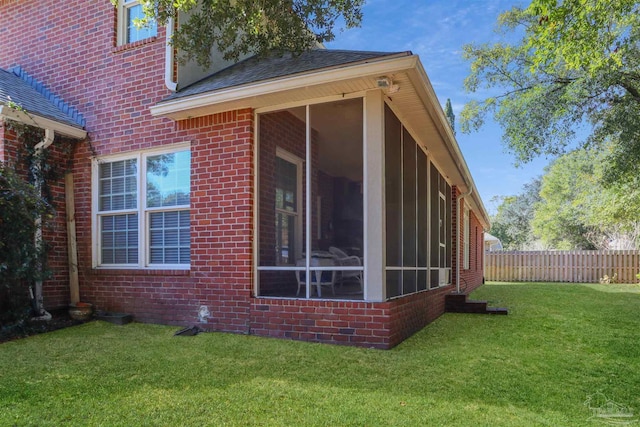 view of property exterior with a sunroom and a lawn