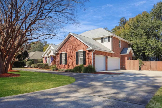 view of property with a garage and a front lawn