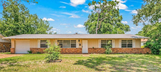 ranch-style house featuring a garage, brick siding, driveway, and a front lawn