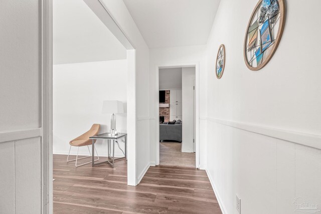 corridor with hardwood / wood-style flooring