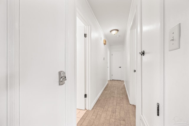 hall featuring light wood-type flooring and ornamental molding