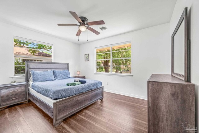 bedroom with dark wood-type flooring and ceiling fan