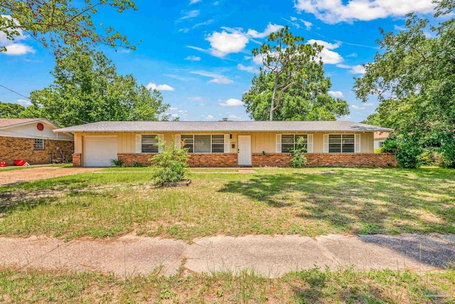 ranch-style home with a garage, driveway, brick siding, and a front yard