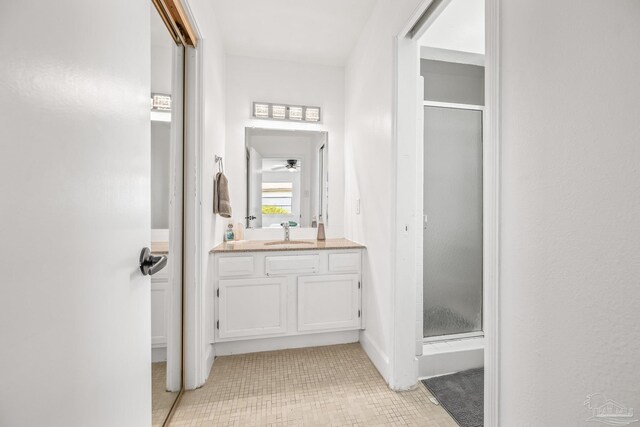 bathroom featuring vanity, tile patterned flooring, ceiling fan, and an enclosed shower