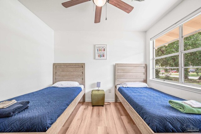 bedroom with wood-type flooring and ceiling fan