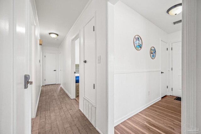 hall with hardwood / wood-style flooring