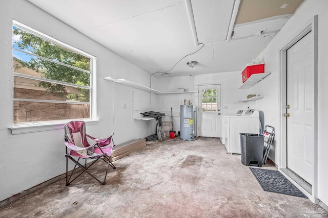 garage featuring water heater and washing machine and dryer