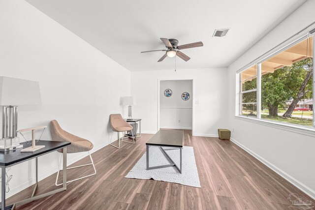 sitting room featuring hardwood / wood-style floors and ceiling fan