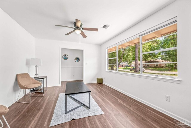 living area with ceiling fan and hardwood / wood-style floors