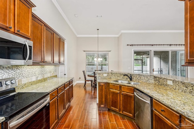 kitchen featuring pendant lighting, stainless steel appliances, dark hardwood / wood-style floors, a chandelier, and sink