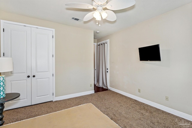 unfurnished bedroom with a closet, carpet, and ceiling fan