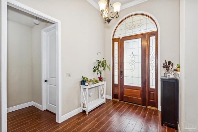 entrance foyer with a chandelier, dark hardwood / wood-style floors, and crown molding