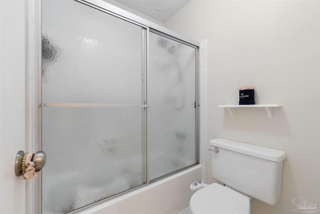 bathroom with bath / shower combo with glass door and toilet