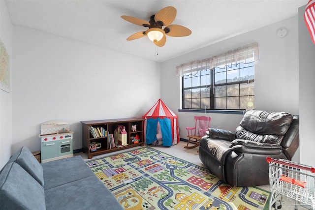 recreation room with light carpet and ceiling fan