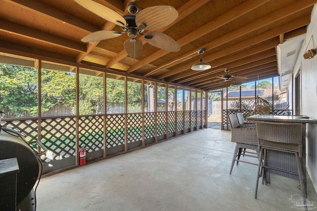 sunroom featuring ceiling fan