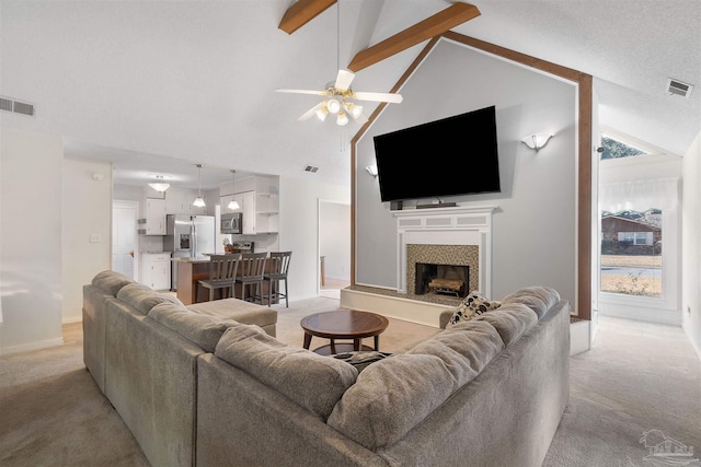 living room with ceiling fan, high vaulted ceiling, light carpet, and beam ceiling